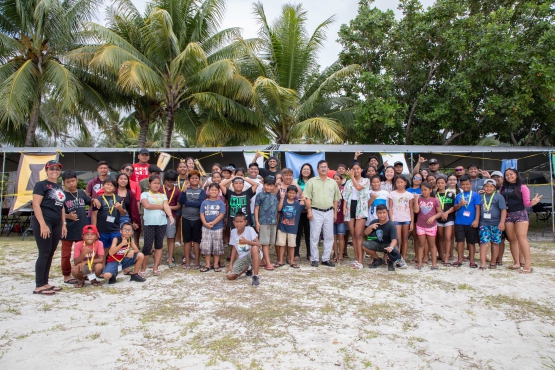 Campers, camp counselors, and staff pose with Rota Mayor Efraim Atalig and his staff.
