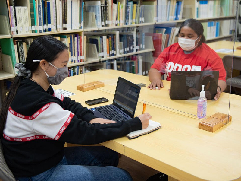 Project PROA tutor Francine Rago (right) tutors a student at the Northern Marianas College library. The College continues to provide a broad range of academic support services to its students during the pandemic.