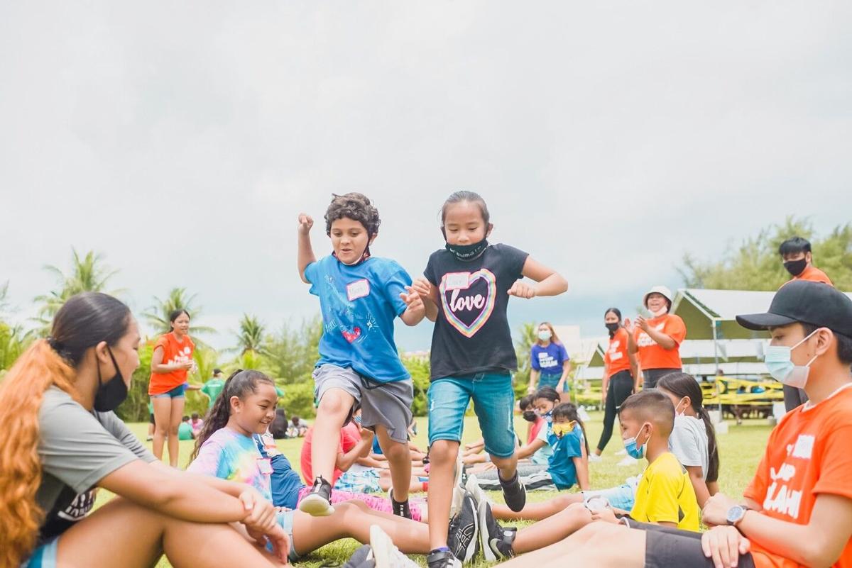 Campers from House of Taga challenge each other during a game of  “Human Ladder”.