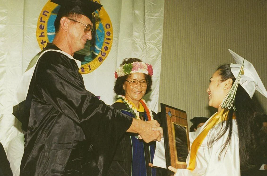 Educator Ivan Propst congratulates a Northern Marianas College graduate. With him is then-NMC President Agnes M. McPhetres. NMC file photo