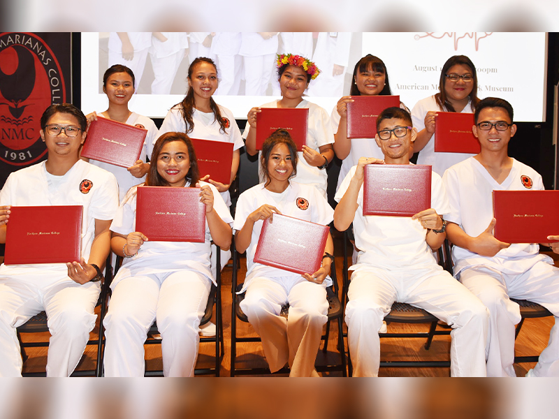 Nursing Students pose for a photo holding their certificates.