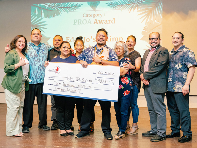 Donovan Castro, center, and his family hold their $20,000 check for his first-place win in the first category of the Supporting Entrepreneurs and Economic Development to Sail or SEED to Sail competition last Friday at the GrandVrio Resort. 