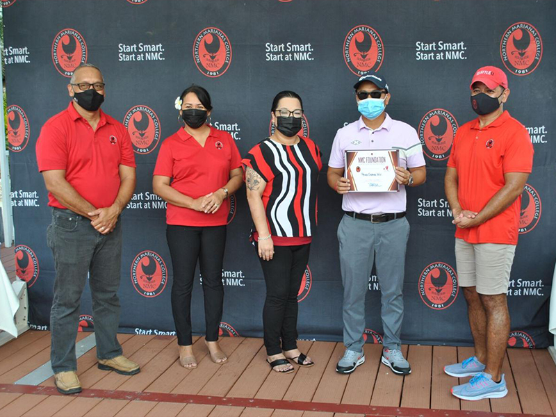 Peng Chang Wu, 2nd right, poses with NMC officials after finishing first in the C Flight of the 16th Annual NMC Golf Tournament. (Photo by: James F. Sablan Jr.)