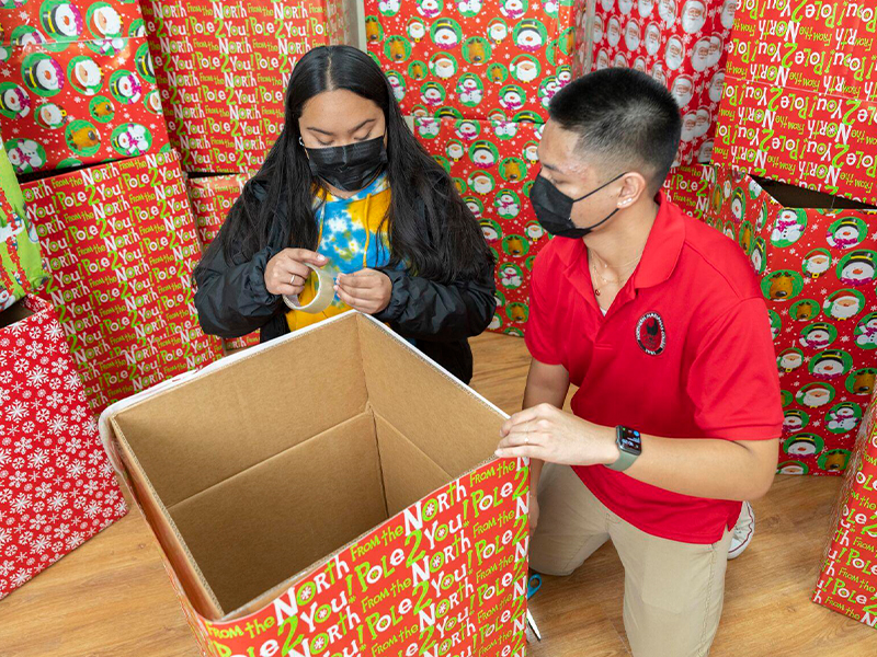 In photo are ASNMC vice president Gerald Crisostimo Jr. and NMC Office of Student Activities and Leadership coordinator Maia Pangelinan preparing toy collection boxes for business and organizational partners who will sponsor the program.