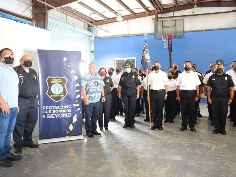 Customs and Quarantine Director Jose Mafnas, third left, Northern Marianas College Criminal Justice Department chair Clement R. Bermudes, left, Special Assistant for Customs Enforcement Col. James C. Deleon Guerrero, second left, and Customs Capt. Reina Camacho join the First Cycle cadets of the Customs and Biosecurity Academy at the Customs Seaport Warehouse on Monday. Photo by Emmanuel T. Erediano