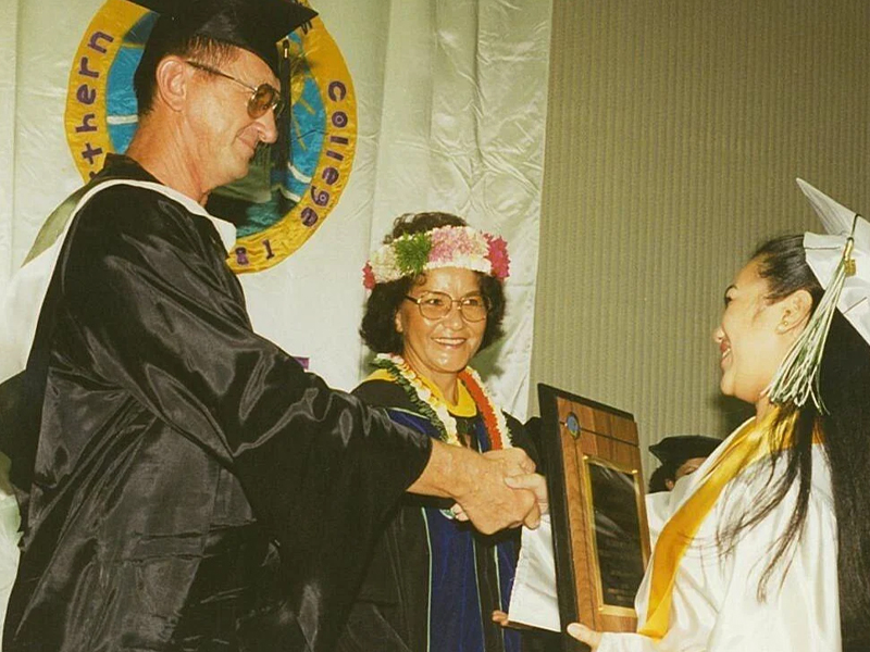 Educator Ivan Propst congratulates a Northern Marianas College graduate. With him is then-NMC President Agnes M. McPhetres. NMC file photo