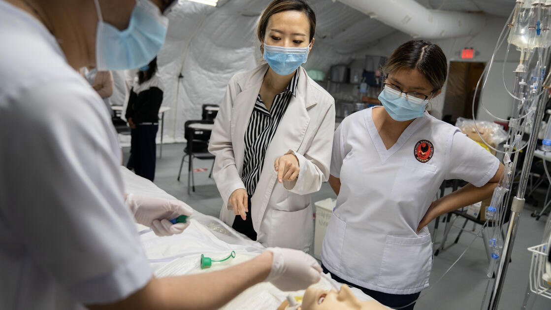 Northern Marianas College nursing instructor Min Jung "Mindy" Song explains a medical procedure to her students during a skills lab. 
